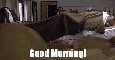 A sergeant waking up sleeping soldiers